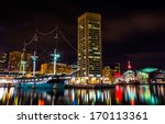 The USS Constellation and World Trade Center at night, in the Inner Harbor of Baltimore, Maryland.