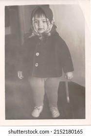 USSR 1950s little girl with a shovel. Transferred property, family archive. Outdated quality. Vintage black and white paper photo