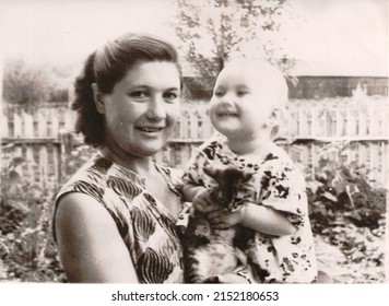 USSR 1950s Mother With Child. Transferred Property, Family Archive. Outdated Quality. Vintage Black And White Paper Photo