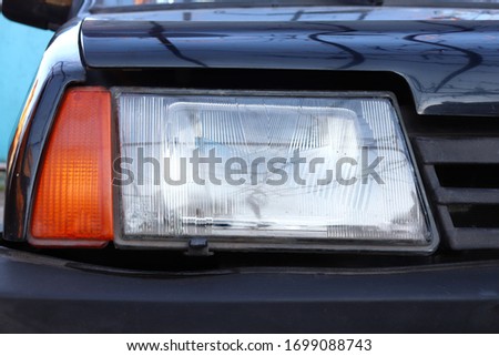 USSR car headlight close-up, black car VAZ 2109, headlight