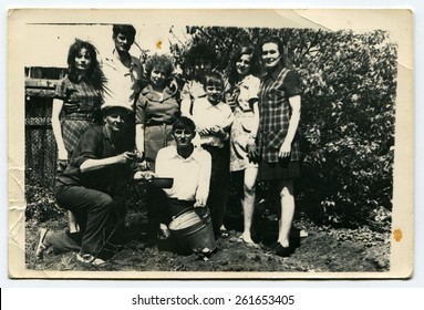 USSR - CIRCA 1970s: Family Working In The Garden In Front Of The House