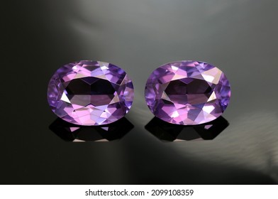 USSR era lab created synthetic alexandrite gemstones pair. Purple color, oval faceted, transparent common vintage gems removed from used earrings made in Russia. Mass market man made stones. Rare now.
