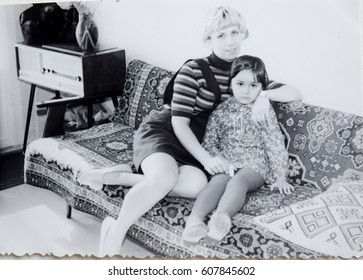 USSR, LENINGRAD - CIRCA 1973: Vintage Photo Of Mom With Daughter Sitting On Sofa In Living Room