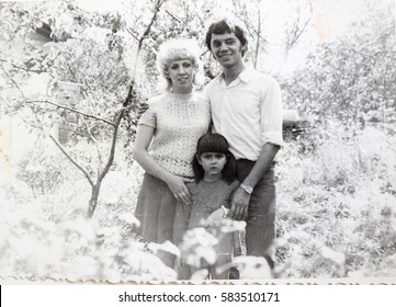 USSR, LENINGRAD - CIRCA 1974: Vintage Photo Of Happy Soviet Family In Summer Park