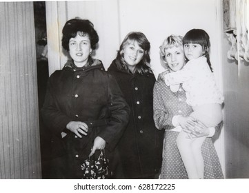 USSR, LENINGRAD - CIRCA 1974: Vintage Family Photo Of Young Mom With Little Daughter And Her Friends In Leningrad, USSR