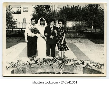 USSR, Petrapavlovsk - CIRCA 1980s: An Antique Photo Shows Group Wedding Portrait Near Forever Fire