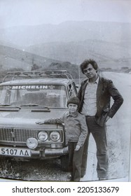 USSR, WESTERN UKRAINE - CIRCA 1983: Vintage Family Photo Of Father And Son Next To Lada Car