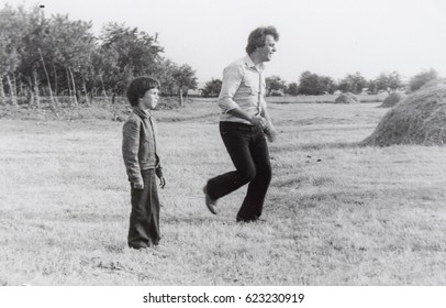 USSR, WESTERN UKRAINE, DOLISHNEE VILLAGE - CIRCA 1982: Vintage Photo Of Father And Son Playing Football Soccer In Western Ukraine, Soviet Union