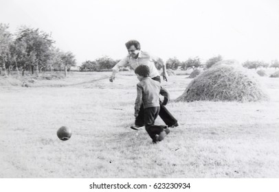 USSR, WESTERN UKRAINE, DOLISHNEE VILLAGE - CIRCA 1982: Vintage Photo Of Dad And Son Playing Football Soccer