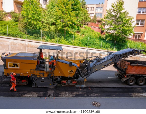 Usti nad Labem, Czech republic -\
5.22.2018: Two road workers operate road milling\
machine
