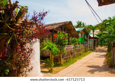 The usual local rural house in Sunny weather. Street. Apo island, Philippines