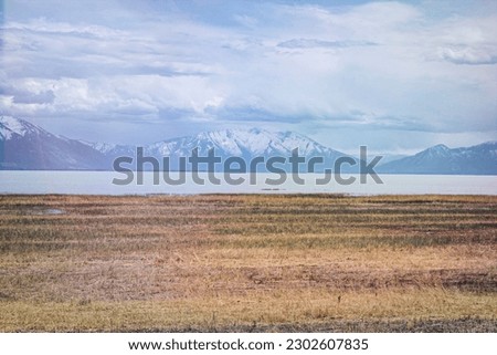 Utah Lake in the Spring with Light Clouds in the Sky and Mountains in the Distance