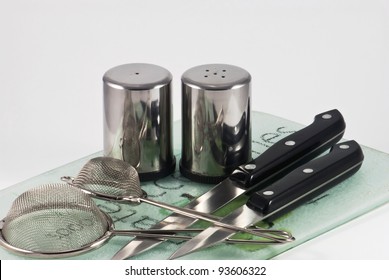 Utensils in a kitchen - knifes, salt and pepper cellars with filters