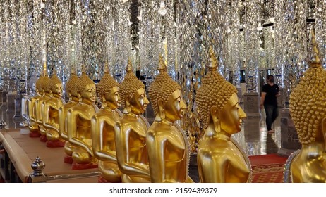 Uthai Thani, Thailand - August 20, 2020 : Buddha Idol In Glass Temple At Wat. Many Gold Idols Inside The Golden Glass Temple.