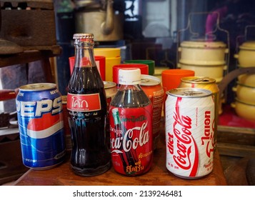 UthaiThani Thailand, 26๋Jul2020,Picture of soft drinks, Pepsi, and Coke in cans and glass bottles. The old vintage style was both displayed on the old wooden floor.