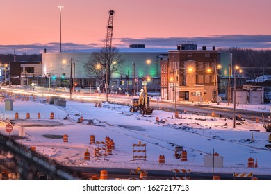 Utica, New York - Jan 20, 2020: Night View Of A Work Zone In The Foreground And Adirondack Bank Center At The Utica Memorial Auditorium In The Background.