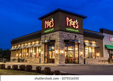 Utica, NY - DECEMBER 02, 2017: A Moe's Southwest Grill Restaurant Lit At Night. Moe's Is A Fast Casual Dining Mexican Food Restaurant With Over 680 Locations In 40 States As Of 2016.