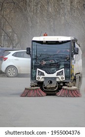 A Utility Car Cleans The Dirt From The Parking Lot