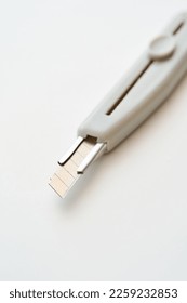 A utility knife placed on a white background