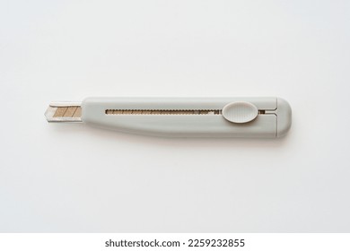 A utility knife placed on a white background