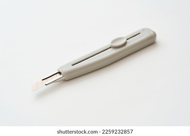 A utility knife placed on a white background