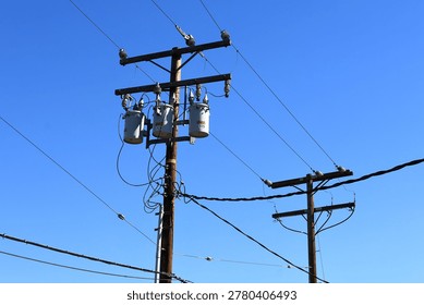 A utility pole with distribution transformers and power lines