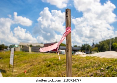 Utility survey stake next to construction site - Shutterstock ID 2183724797