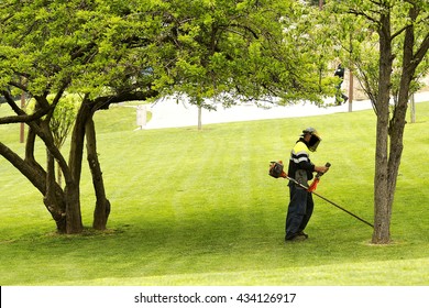 Utility Worker Of Municipality  With  Brush Cutting For Remove Grass In City Park