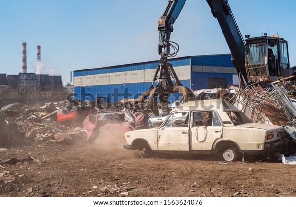 Utilization of the car. Old car at the\
dump of scrap metal. Utilization of the car at the\
dump.