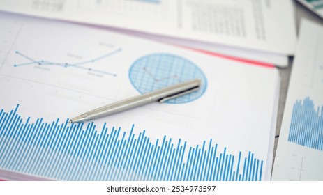 Utilizing graphs and various statistics on financial documents alongside a pen aids in comprehensive analysis