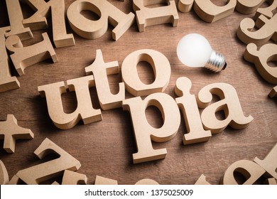 UTOPIA wood word in scattered wood letters with glowing light bulb