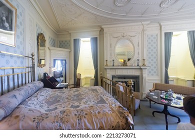 UTRECHT, NETHERLANDS - AUGUST 09, 2022: View Of Guest Bedroom Interior Furnished With Iron Bed And Wooden Carved Victorian Style Furniture In De Haar Castle..