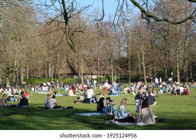 Utrecht, Netherlands - Feb 24 2021: People enjoying spring in the city park as corona restrictions are eased. 