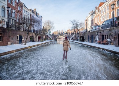 Utrecht, The Netherlands - February 14th 2021: On Valentine's day, People ice skate on the frozen Oudegracht canal in Utrecht.