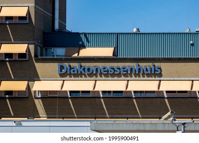 Utrecht, The Netherlands - June 14, 2021: Closeup Of Logo And Name Above The Main Entrance Of The Diakonessenhuis Hospital Exterior Facade With Sun Shades Down In Front Of The Windows On Sunny Day