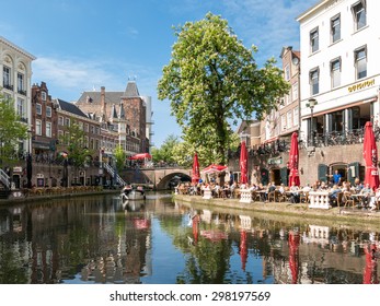 UTRECHT, NETHERLANDS - MAY 21, 2015: Oudaen Castle and people on outdoor terrace of restaurants alongside Oudegracht canal in the city of Utrecht, Netherlands