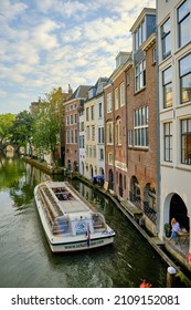 Utrecht, The Netherlands - September 25 2021: Canal cruise boat on   Oudegracht (old canal) with historic canalside buildings