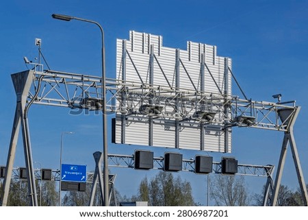 Utrecht, Netherlands. Technical back view of a steel highway traffic gantry structure with dynamic matrix signs and speed surveillance cameras.