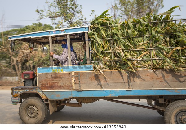 Uttaradit - Thailand , Mar 17 - 2016 : Thai
farmer is driving Mini-tractor truck use for farm on the road
,Uttaradit ,Thailand.
