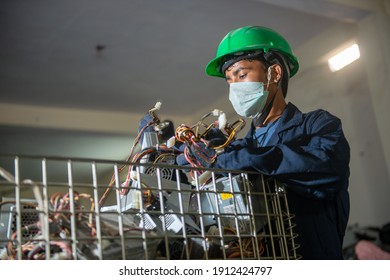 Uttarakhand, India, January 29 2021 : Worker With Discarded Or Obsolete Spare PC Parts And Accessories Such As Mainboards, Colored Cables And Connectors, Electronic Waste Recycling Plant At Haridwar