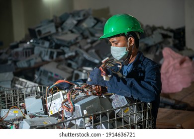 Uttarakhand, India, January 29 2021 : Worker With Discarded Or Obsolete Spare PC Parts And Accessories Such As Mainboards, Colored Cables And Connectors, Electronic Waste Recycling Plant At Haridwar