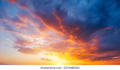 Utterly spectacular sunset with colorful clouds lit by the sun. Scenic image of textured sky. Perfect summertime wallpaper. Bright epic sky. Photo of dramatic evening light and fiery orange sunset.