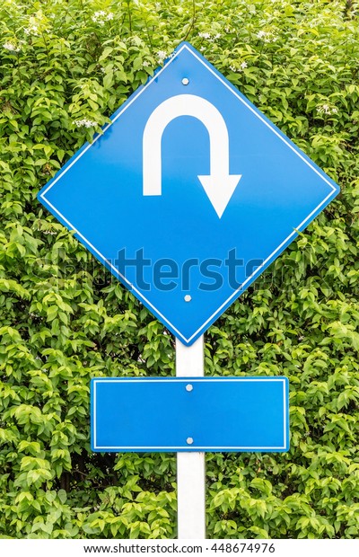 U-turn\
traffic sign for directions in outdoor car\
park.