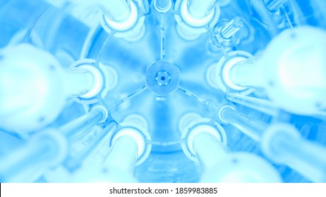 UV Water Purifier. Media. Close-up Of Bright Ultraviolet Flasks In Device. UV Device With Blue Light For Cleaning Water From Chlorine. Futuristic UV Flasks