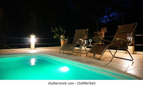 Uvita, Costa Rica-March 2018: Spectacular Outdoor Scenery Of Real Estate Property In Jungle Environment With A Swimming Pool During The Nighttime With Colourful Decorative Lights Turned On. 
