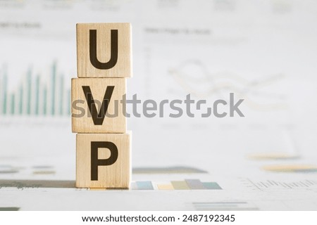 UVP - Unique Value Proposition, word made with building wooden blocks on table in sunlight.
