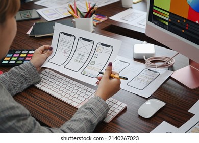 UX designer planning application template layout framework for mobile phone at office desk. - Shutterstock ID 2140267023