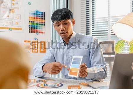 A UX designer presents wireframes, interface layouts, and mobile app concepts during a collaborative design workshop, improving user experience, product strategy, and digital interface planning.