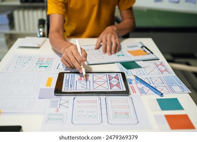 UX developer and ui designer brainstorming about mobile app interface wireframe design with customer breif and color code, User experience concept.	