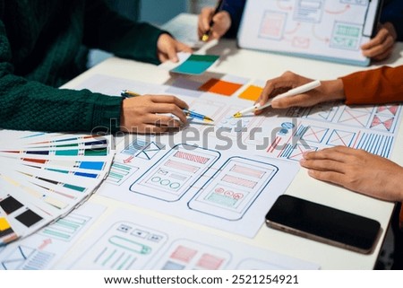 UX developer and ui designer brainstorming about mobile app interface wireframe design with customer breif and color code, User experience concept.